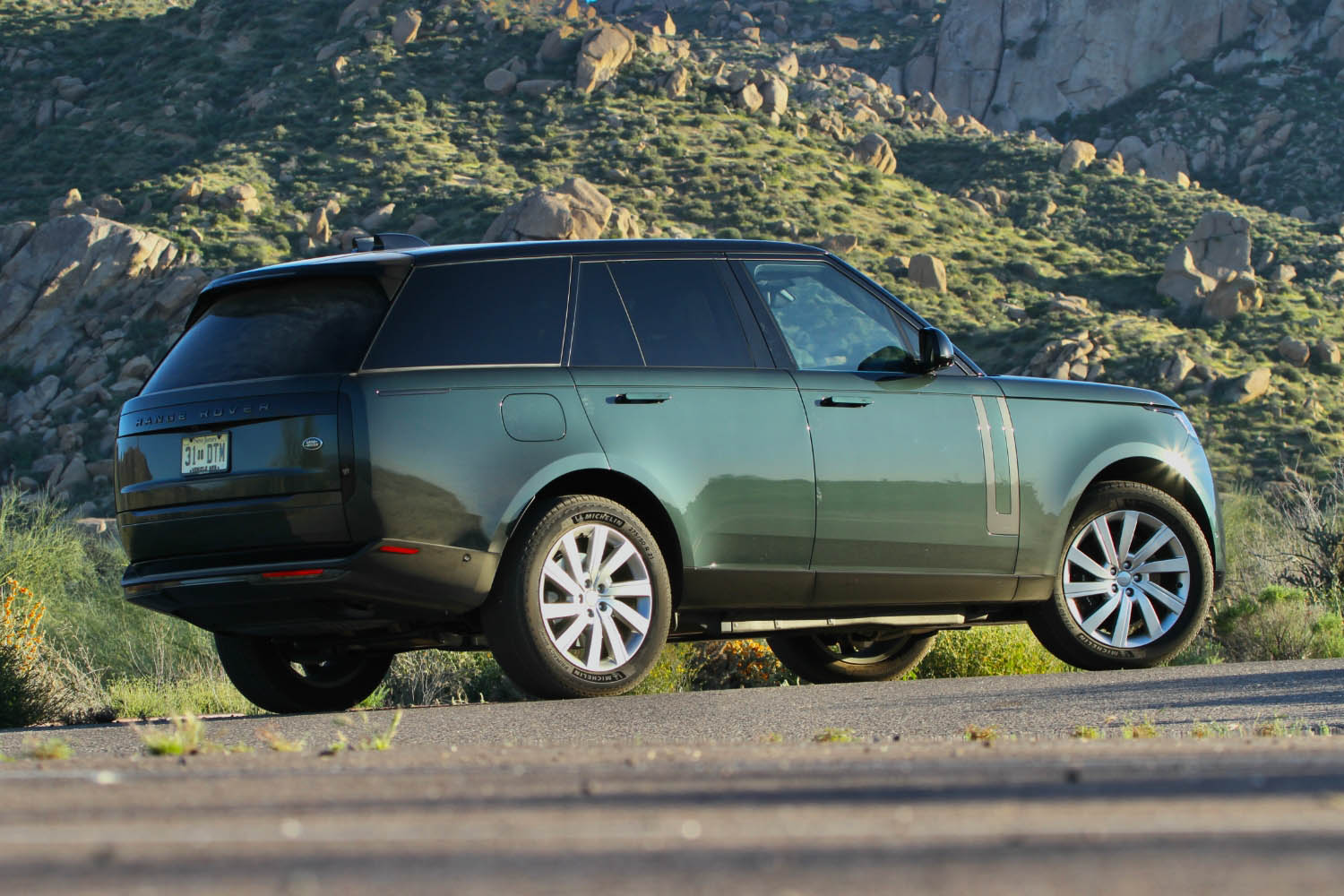 Rear three-quarter view of a 2023 Land Rover Range Rover plug-in hybrid in Belgravia Green