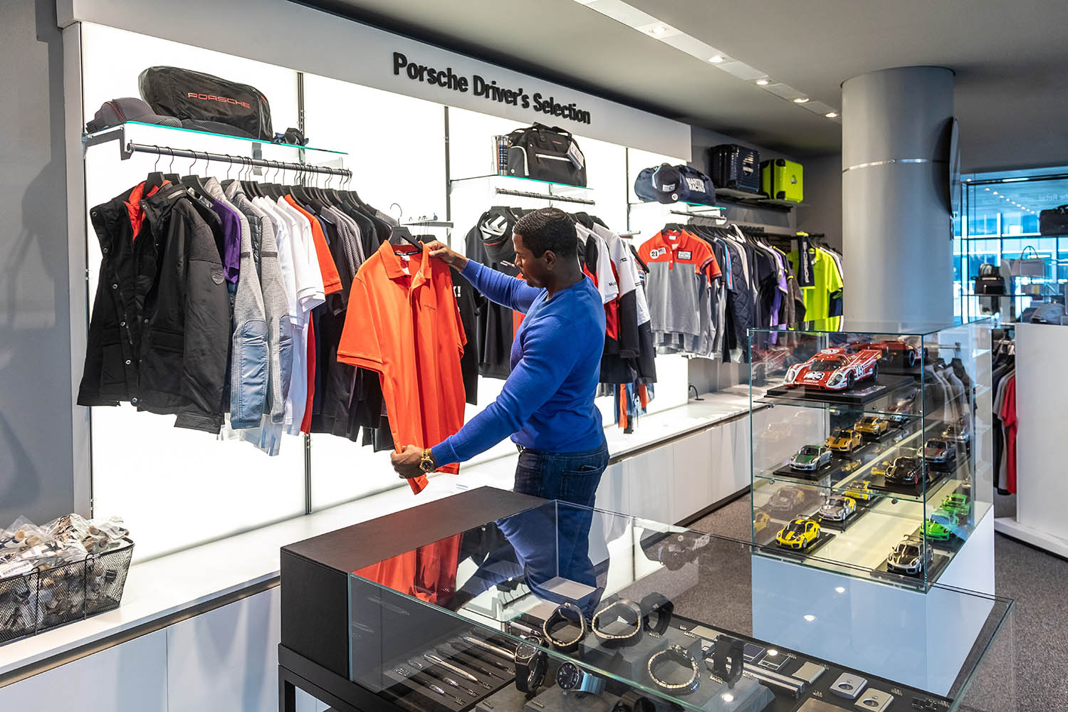 A man inside Atlanta's Porsche Experience Center looking at Porsche clothing