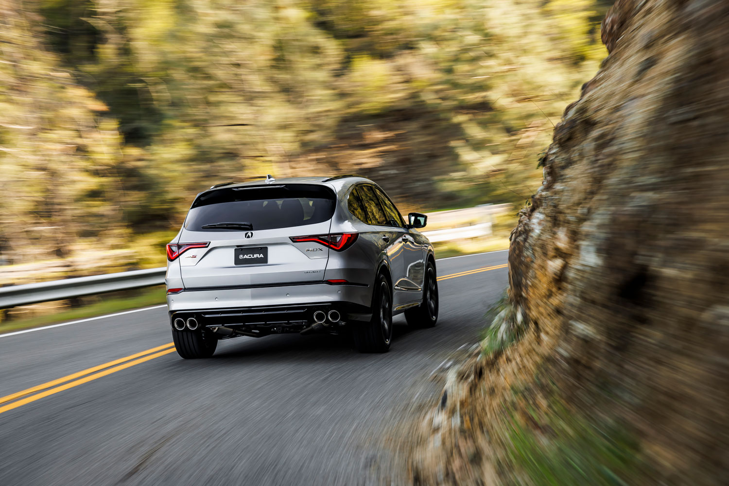 2023 Acura MDX Type S driving on a winding mountain road