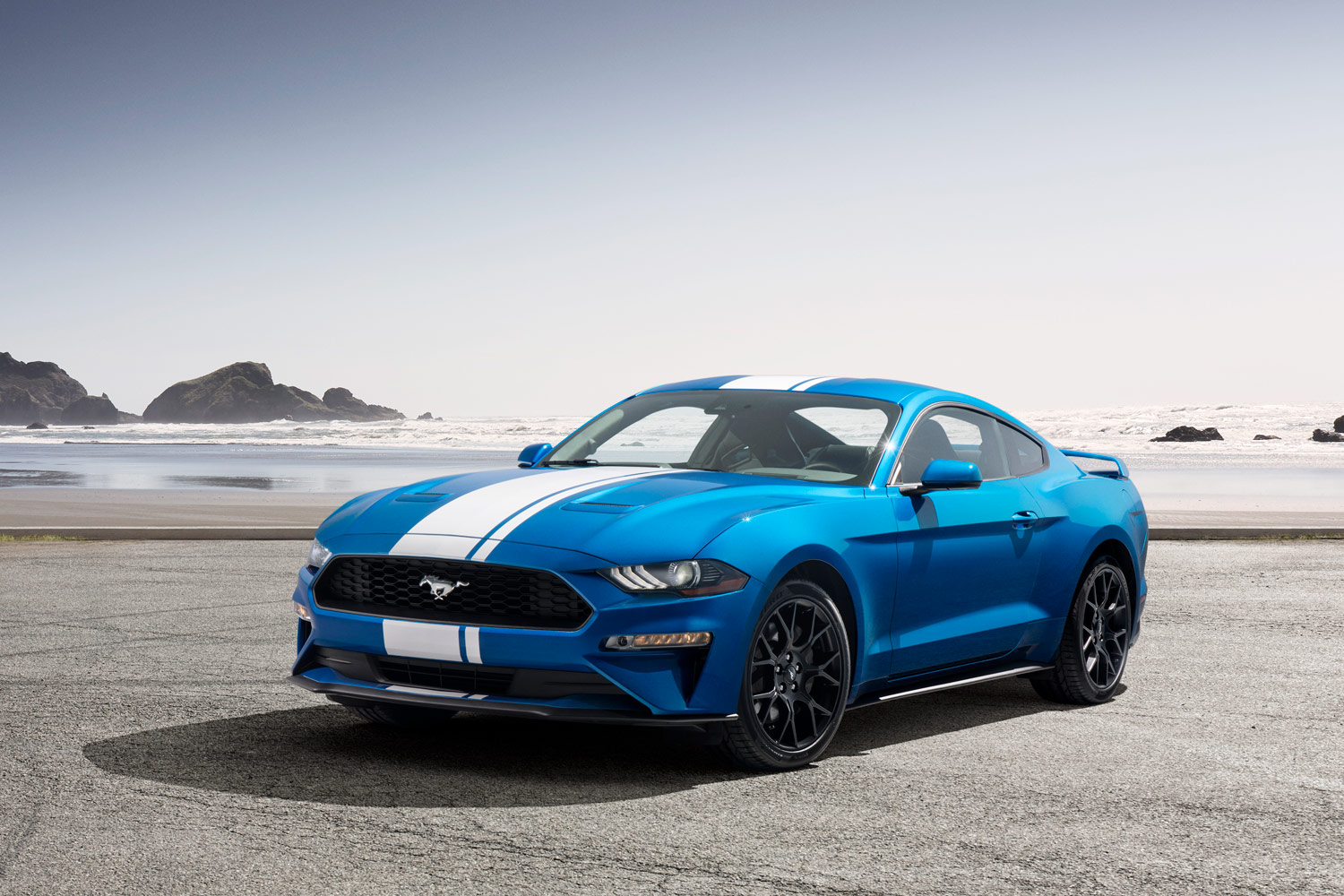 A blue Ford Mustang with white racing stripes