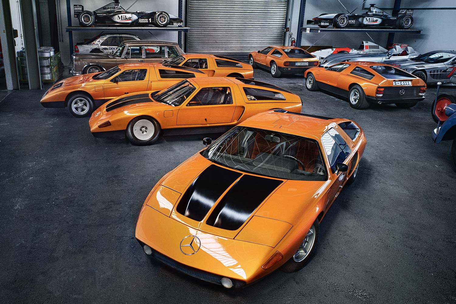 Several orange Mercedes-Benz sports cars