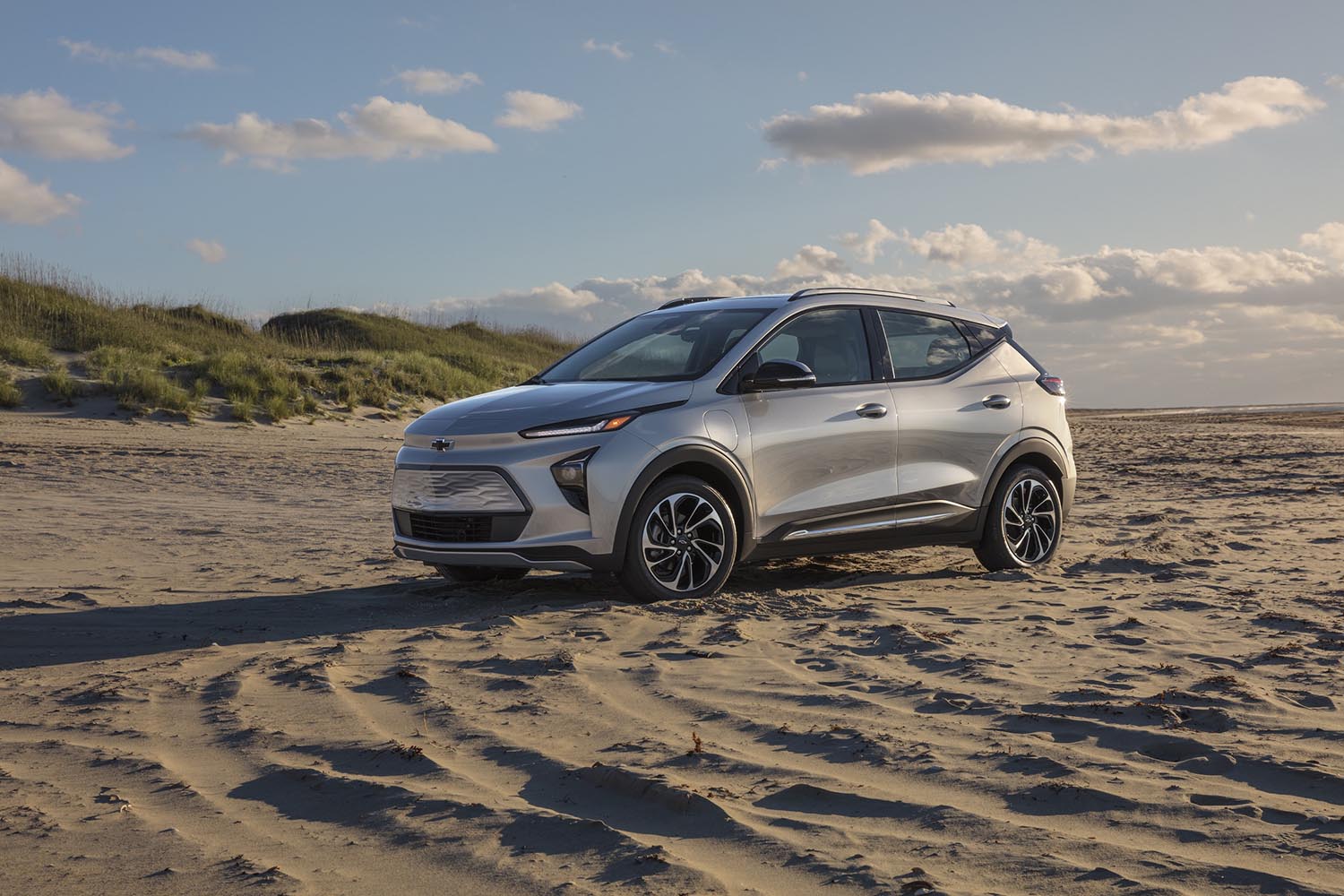 Chevrolet Bolt EUV in silver parked on a sandy beach