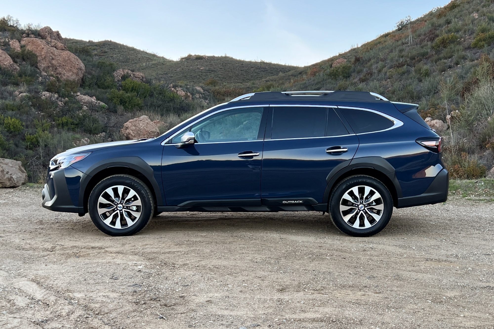 Cosmic Blue 2023 Subaru Outback side view in the mountains