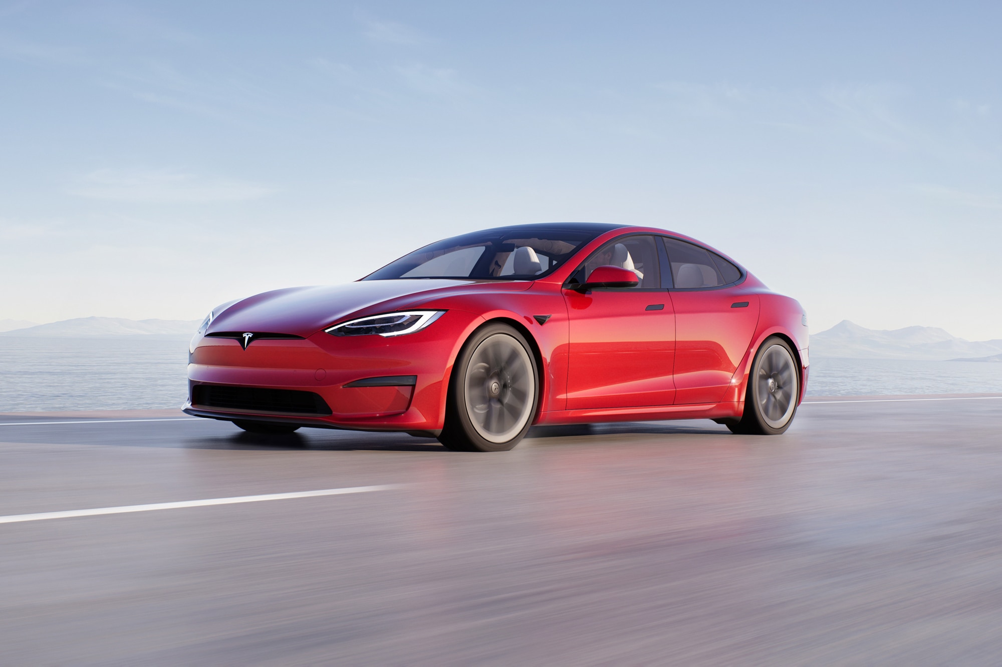 Red Tesla Model S driving down highway