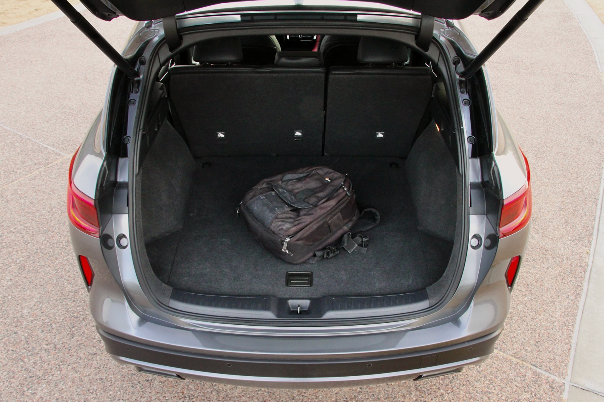 Gray 2023 Infiniti QX50 Sport open cargo space with backpack inside