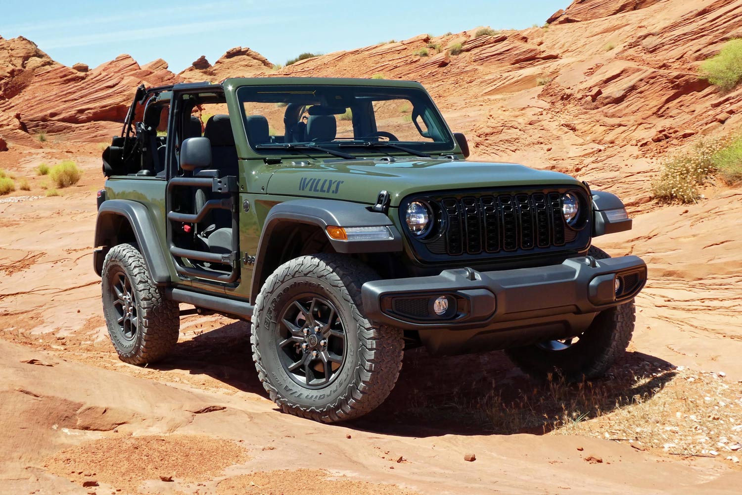Front three-quarter view of a green 2024 Jeep Wrangler WIllys
