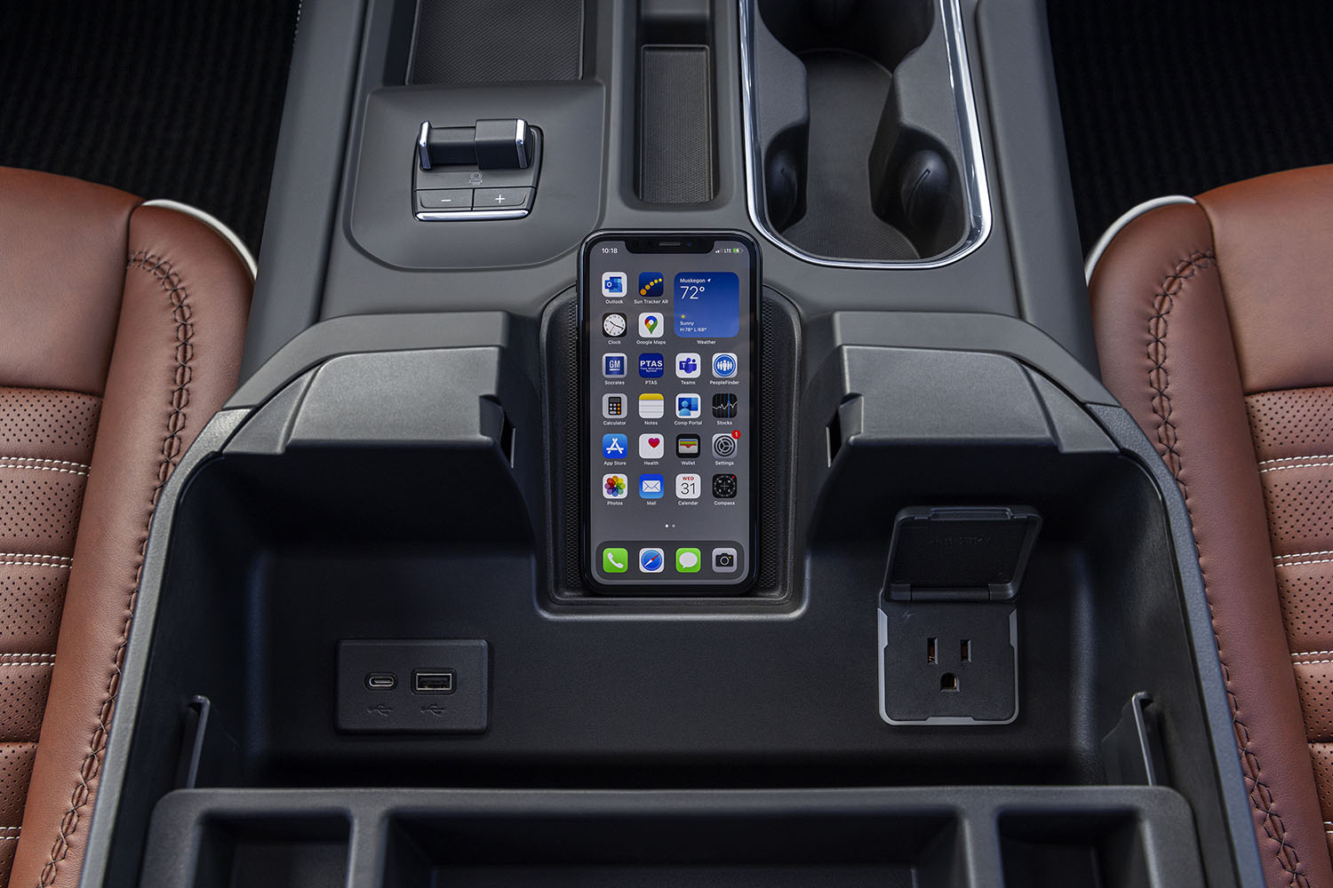 An iPhone in the center console of a 2024 GMC Sierra 2500 HD Denali Ultimate truck