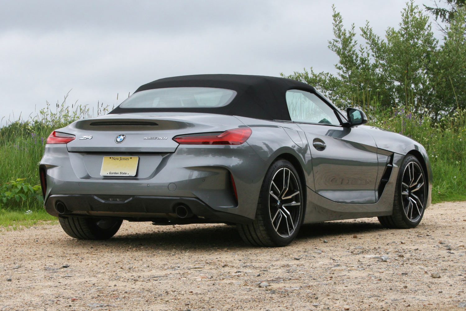 Read three-quarter view of a silver 2024 BMW Z4 with the top up