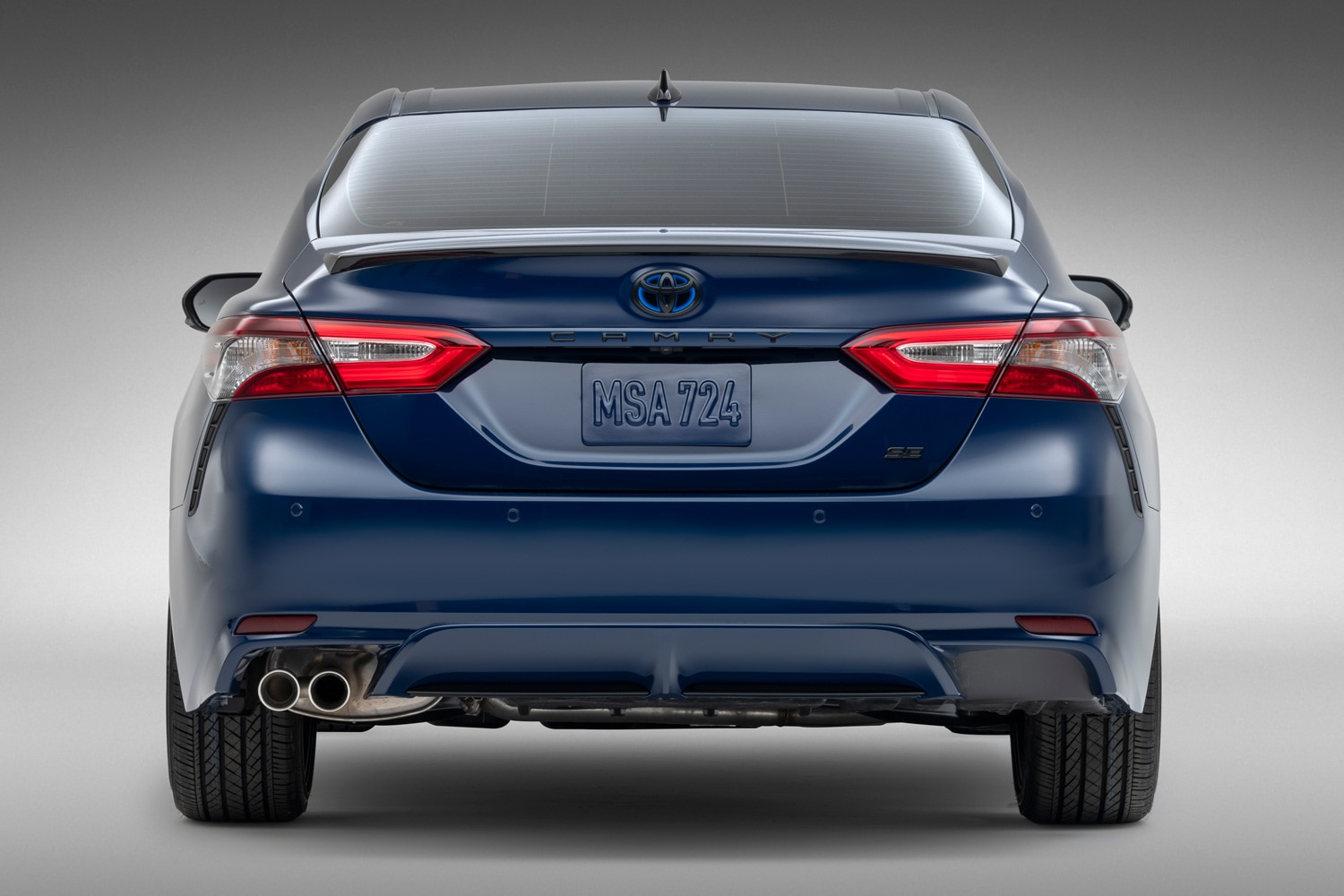 Rear view of a blue 2023 Toyota Camry Hybrid