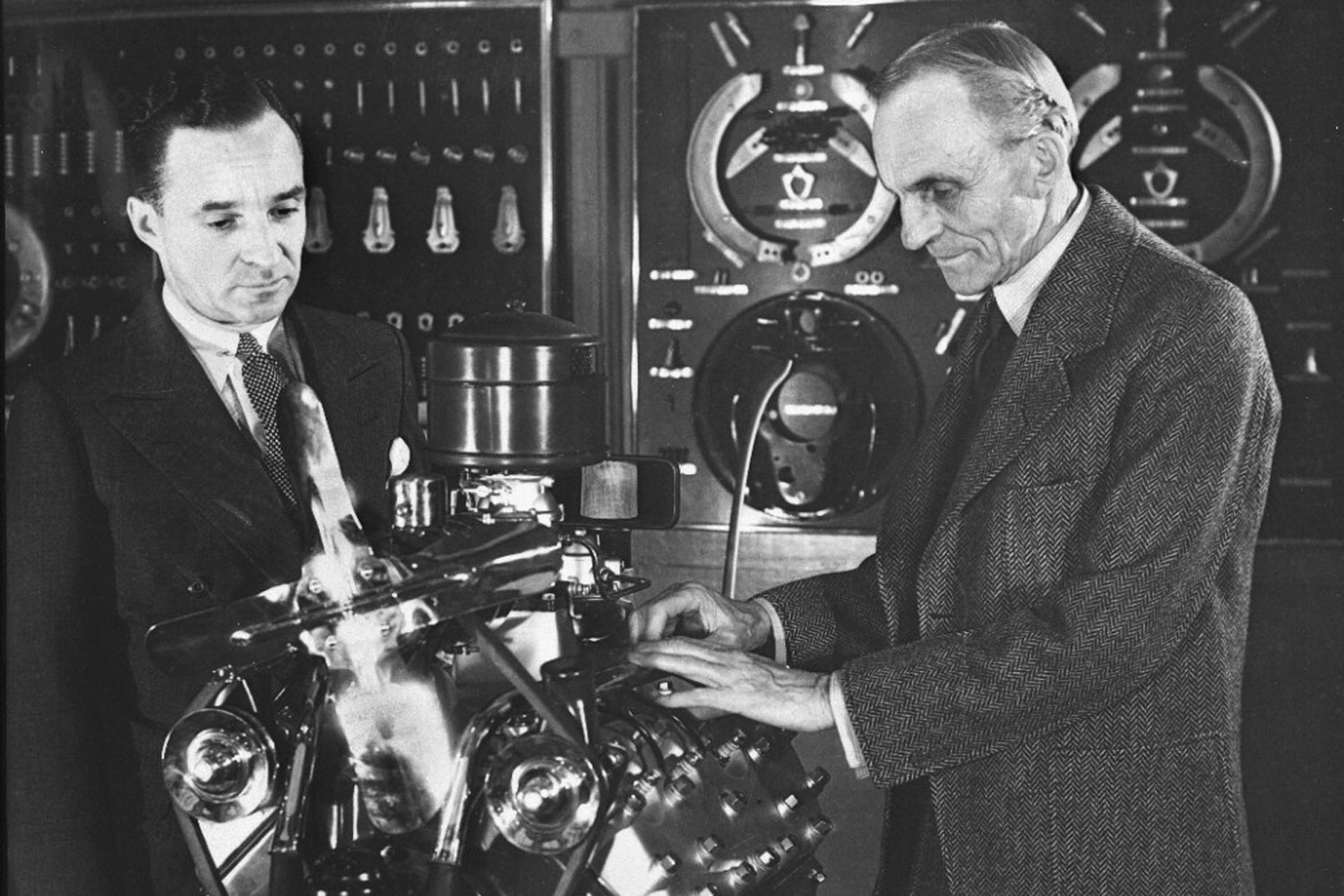 Henry and Edsel Ford with an early V8 engine.