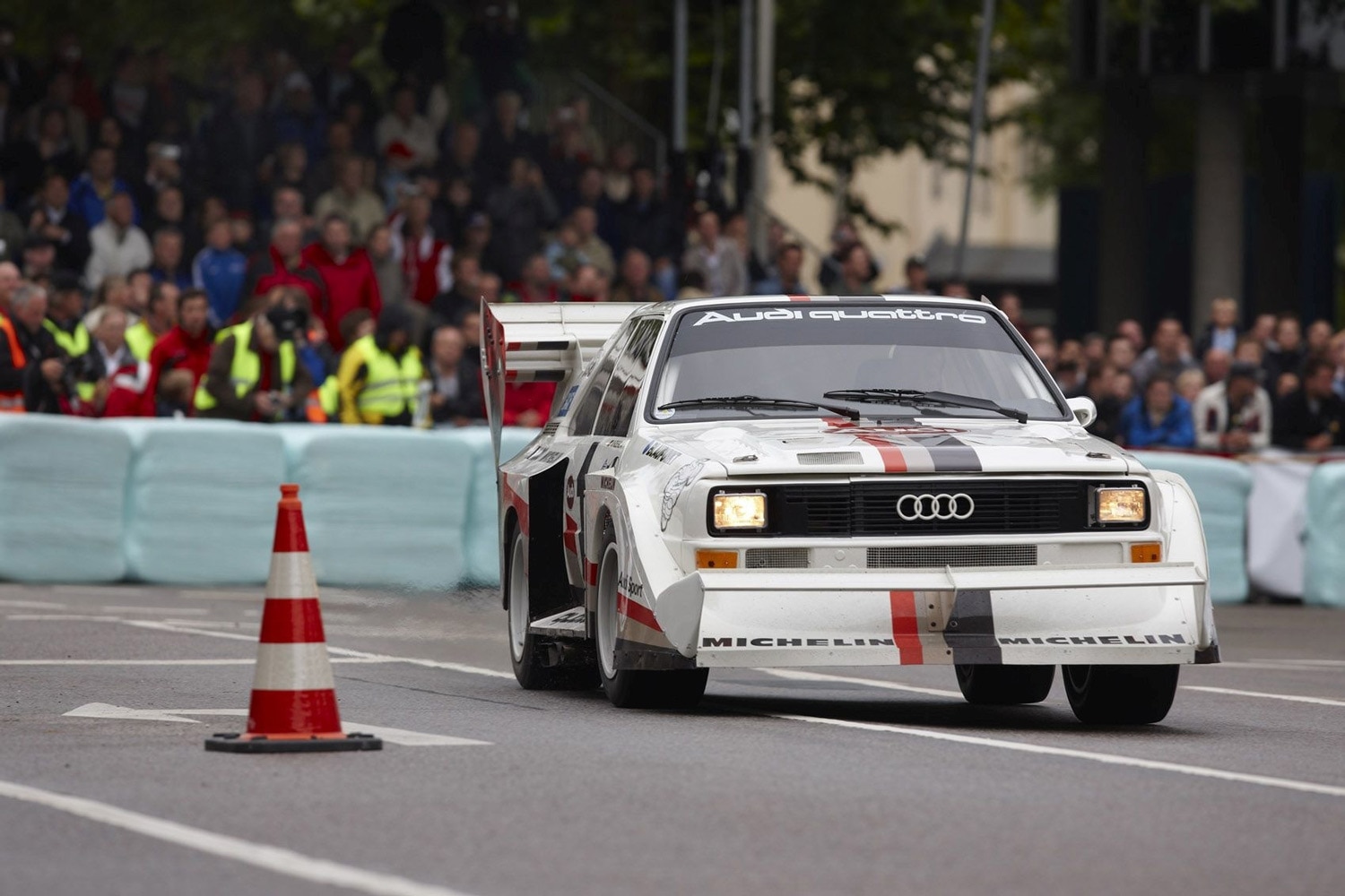 Front three-quarter view of a white Audi Quattro on the starting line at Pikes Peak