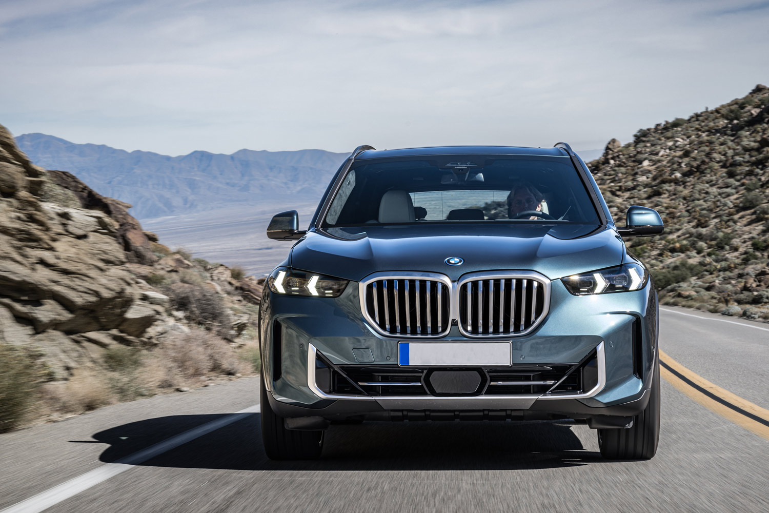 Front view of a metallic-blue 2024 BMW X5