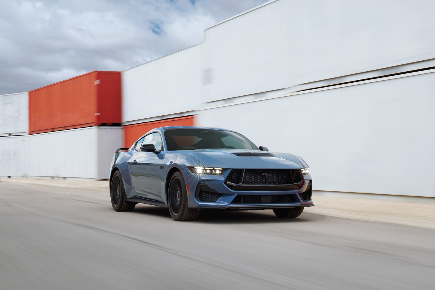 Front three-quarter view of a blue Ford Mustang