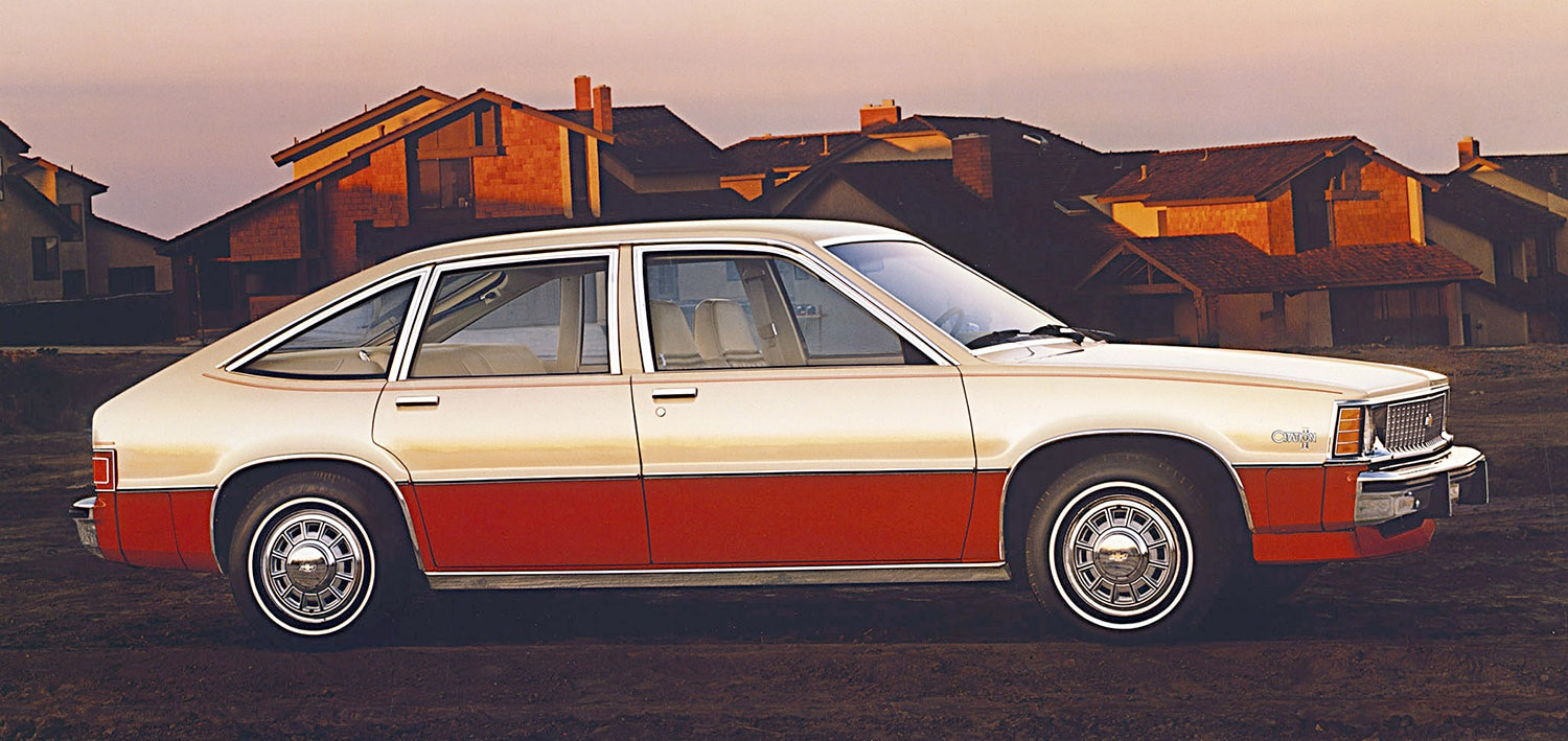 1980 Chevrolet Citation (X-body) five-door hatchback sedan in white-red two-tone parked in front of a new housing tract
