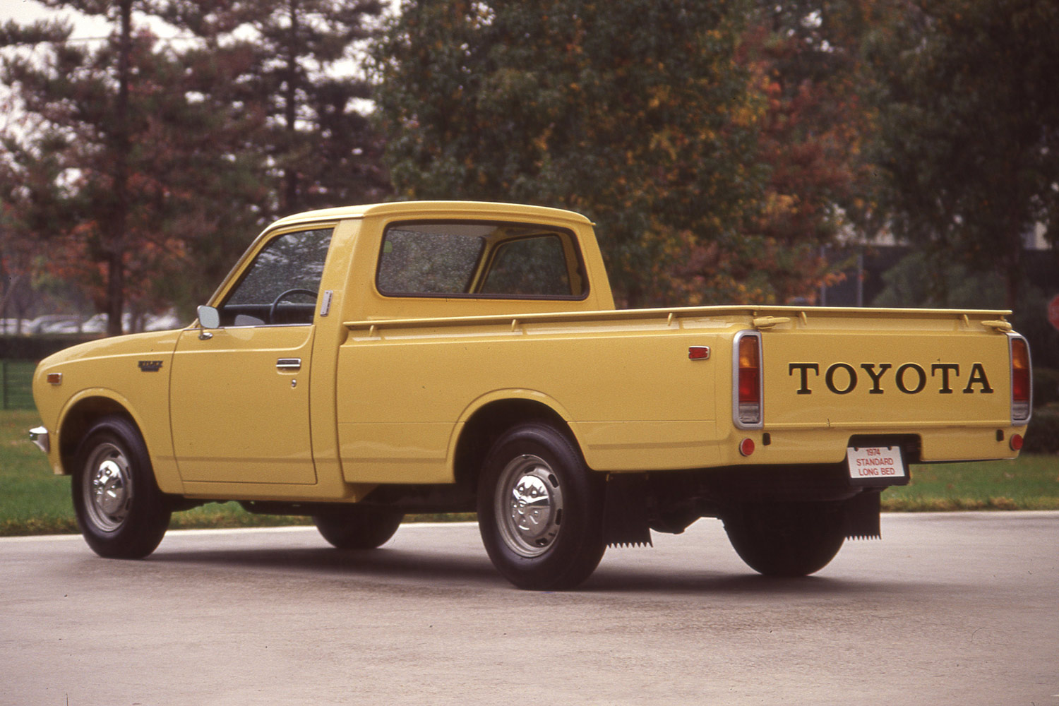 Rear three-quarter view of a yellow 1976 Toyota Hilux, known in the U.S. as the Toyota Pickup