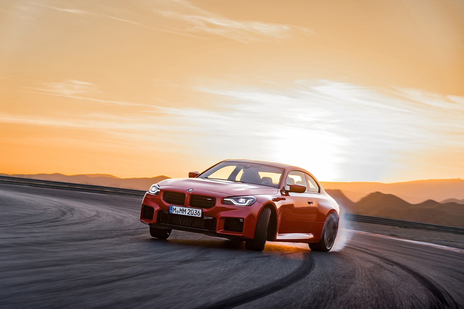 2023 BMW M2 in orange drifting on a track