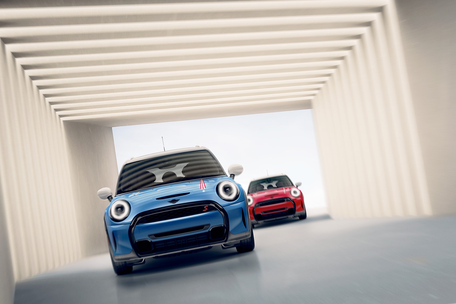 2023 Mini Cooper S Hardtop in Island Blue being chased by a red Mini Cooper