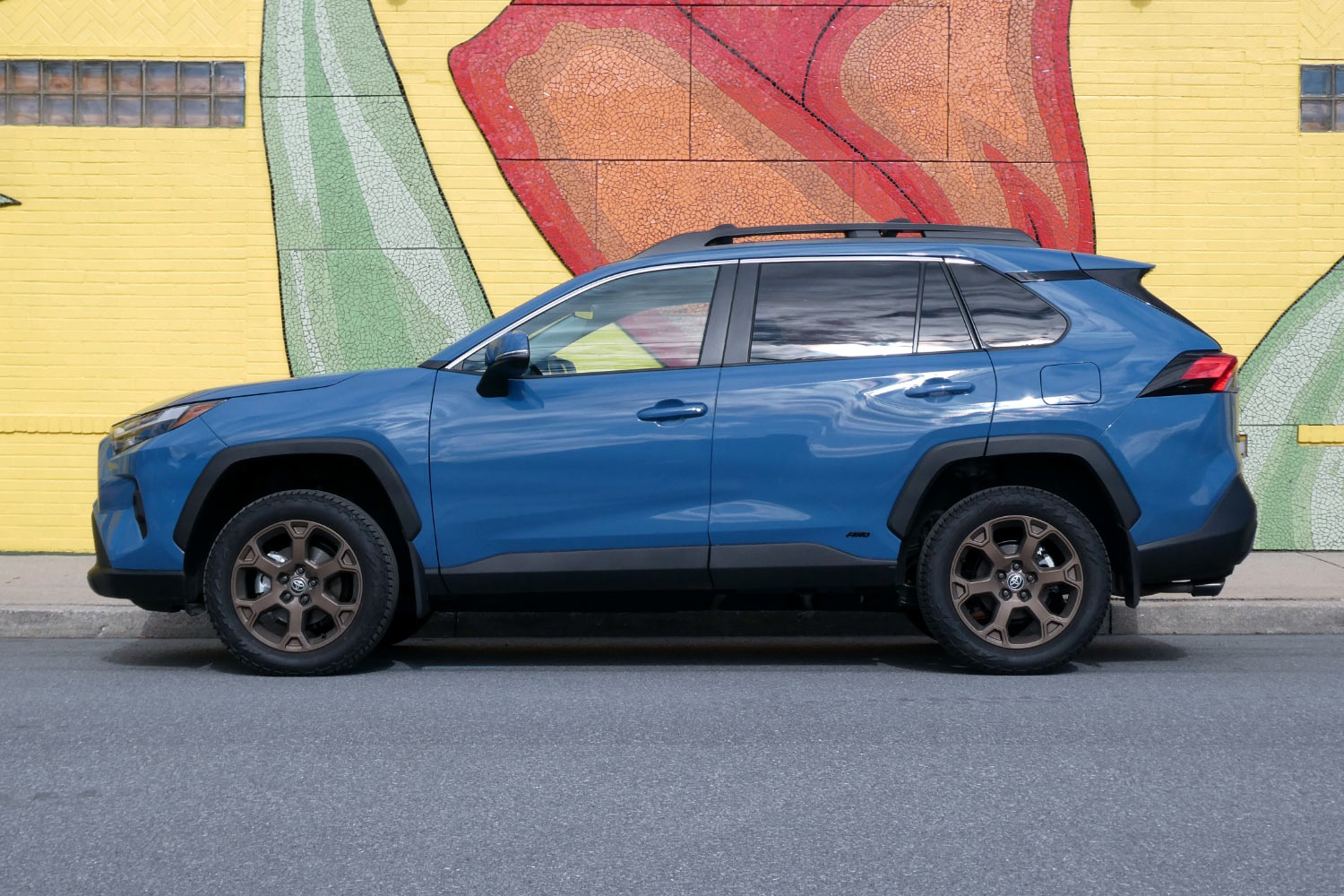 2023 Toyota RAV4 Hybrid Woodland Edition in Cavalry Blue by mural covered wall