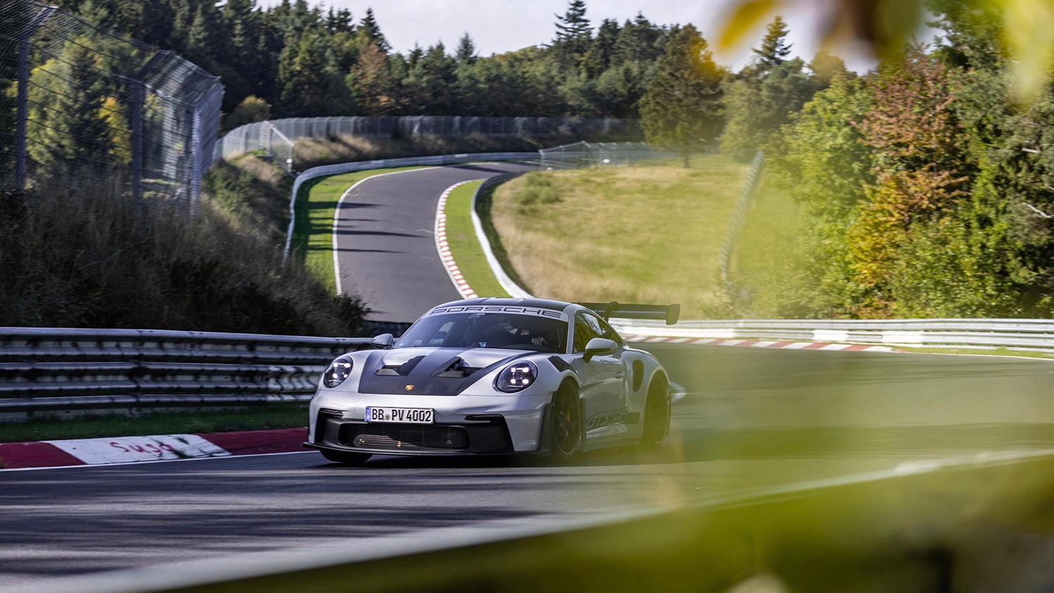 Porsche 911 GT3 RS in silver driving on the Nundefinedrburgring