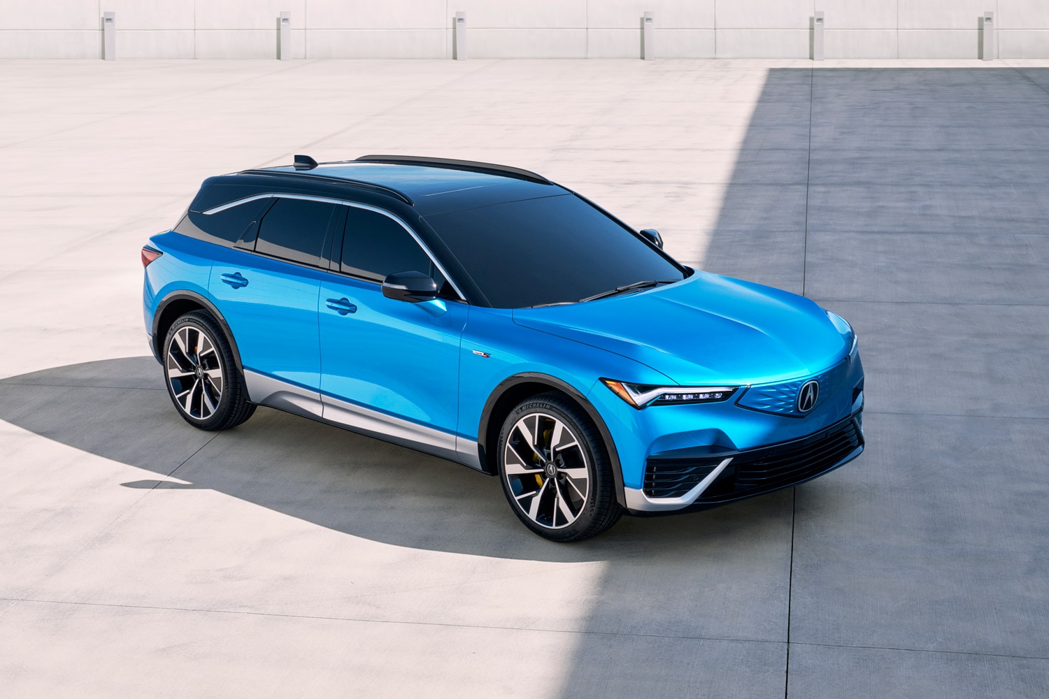 2024 Acura ZDX Type S in blue parked on open concrete area