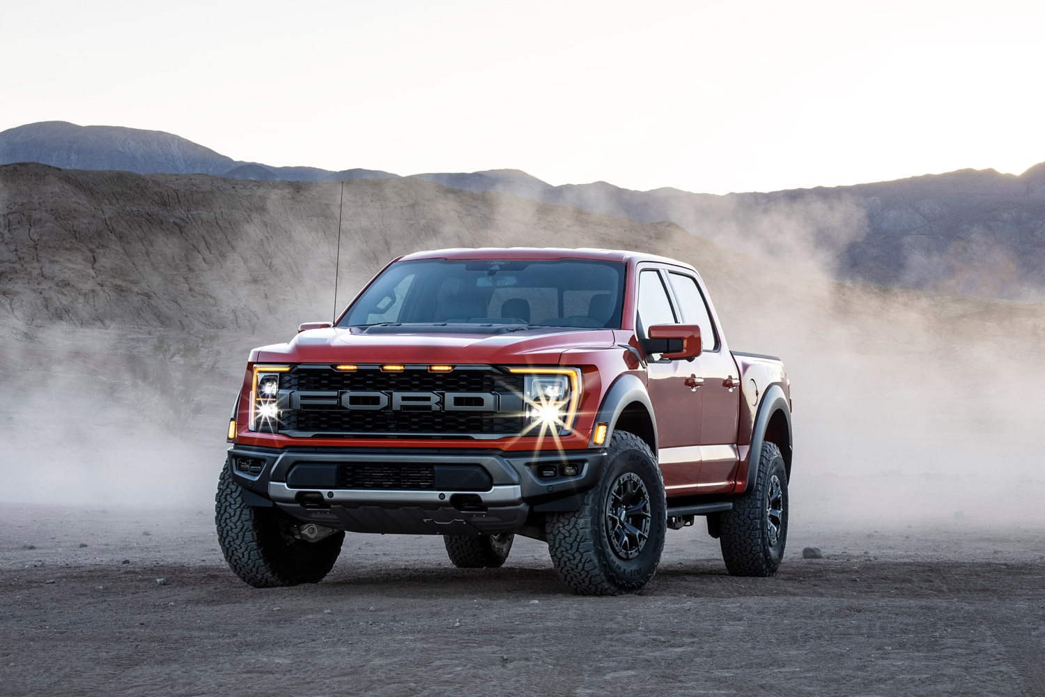 2023 Ford F-150 Raptor on dirt with dust in background