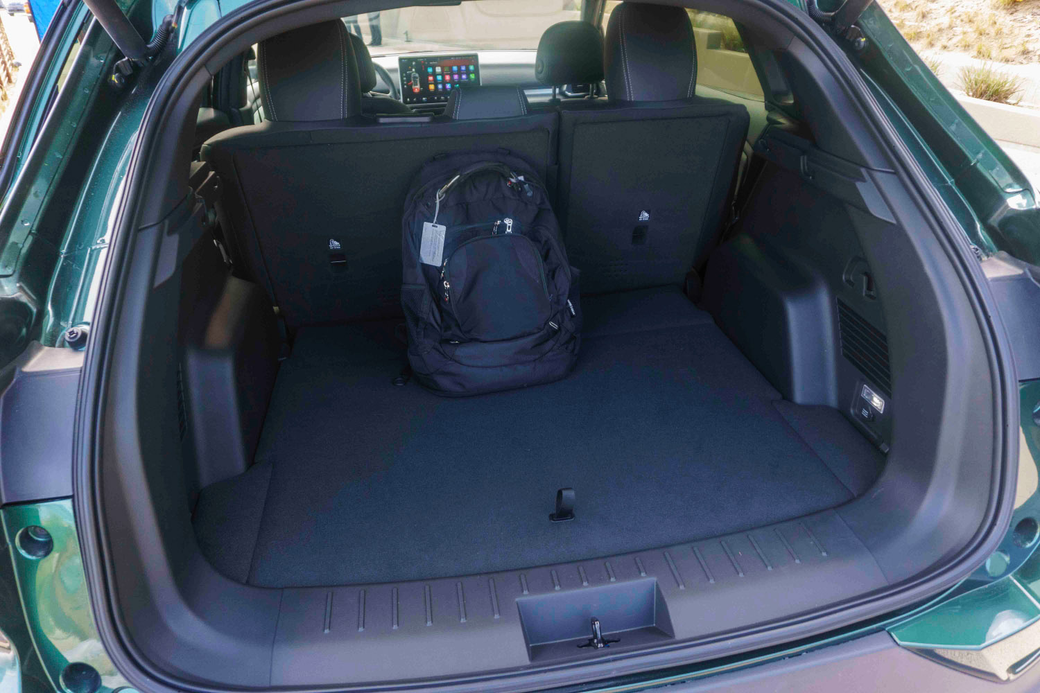 : 2023 Vinfast VF 8 interior, rear cargo area with backpack inside