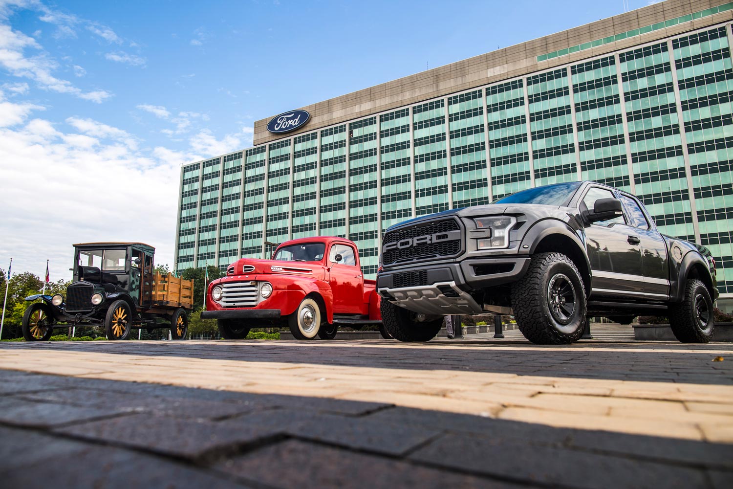Three Ford pickup trucks lined up with 1917 Ford Model TT on the left.