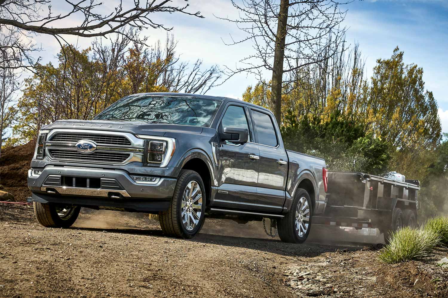 2021 Ford F-150 towing utility trailer on dirt road