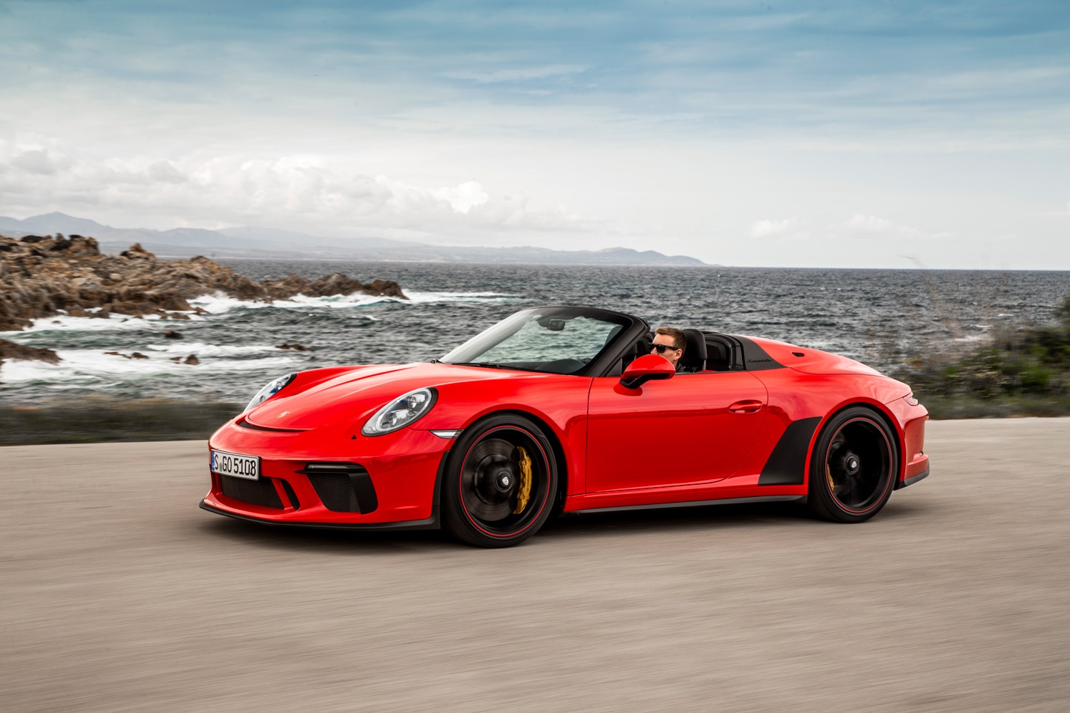 2019 Porsche 911 Speedster in red driving by the ocean