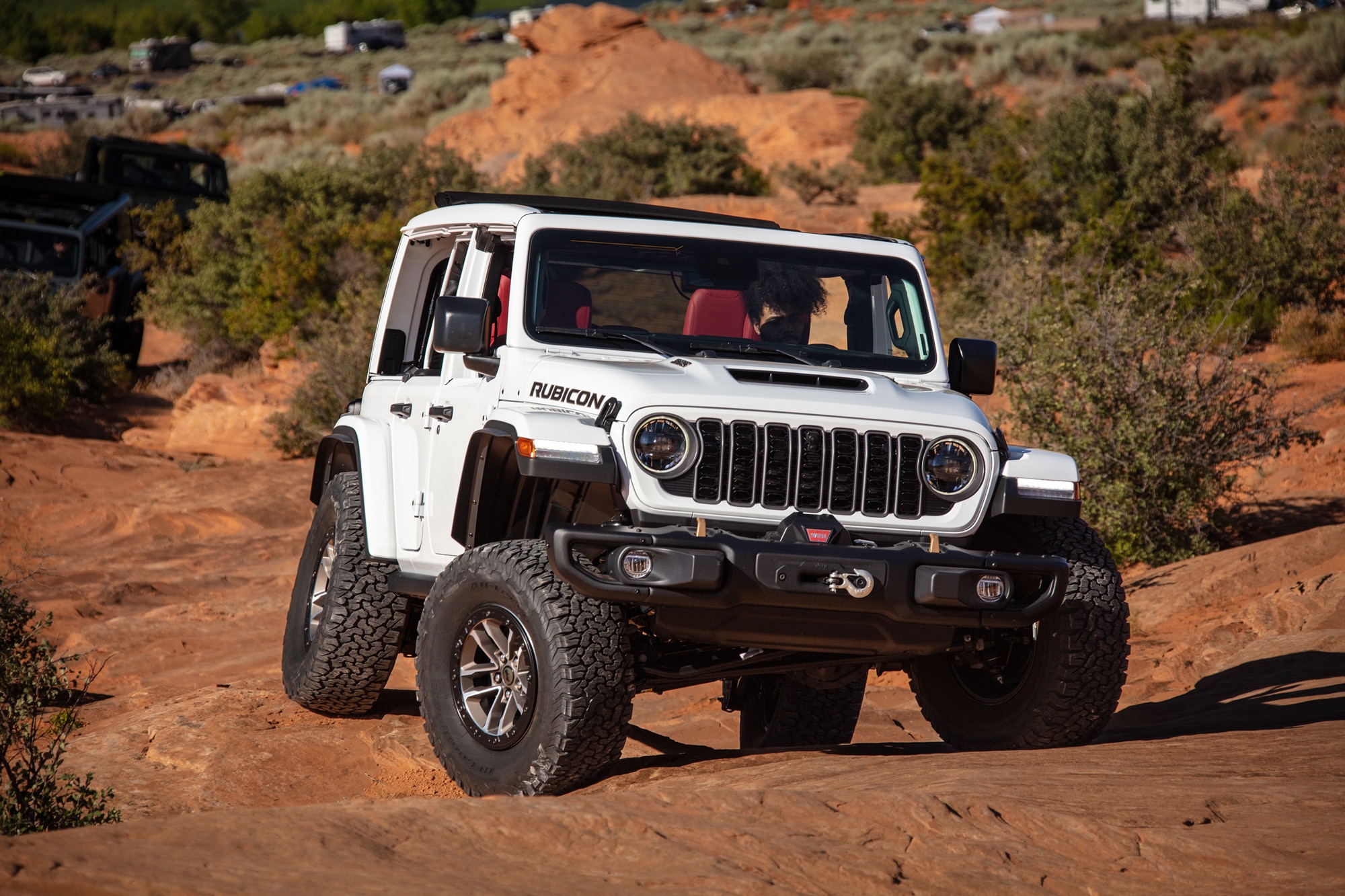 White 2024 Jeep Wrangler Rubicon 392 in the desert with red interior