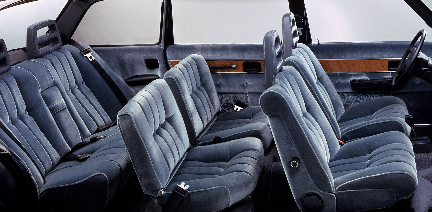 1974 Volvo 264 TE interior with three rows of seating and velour galore.