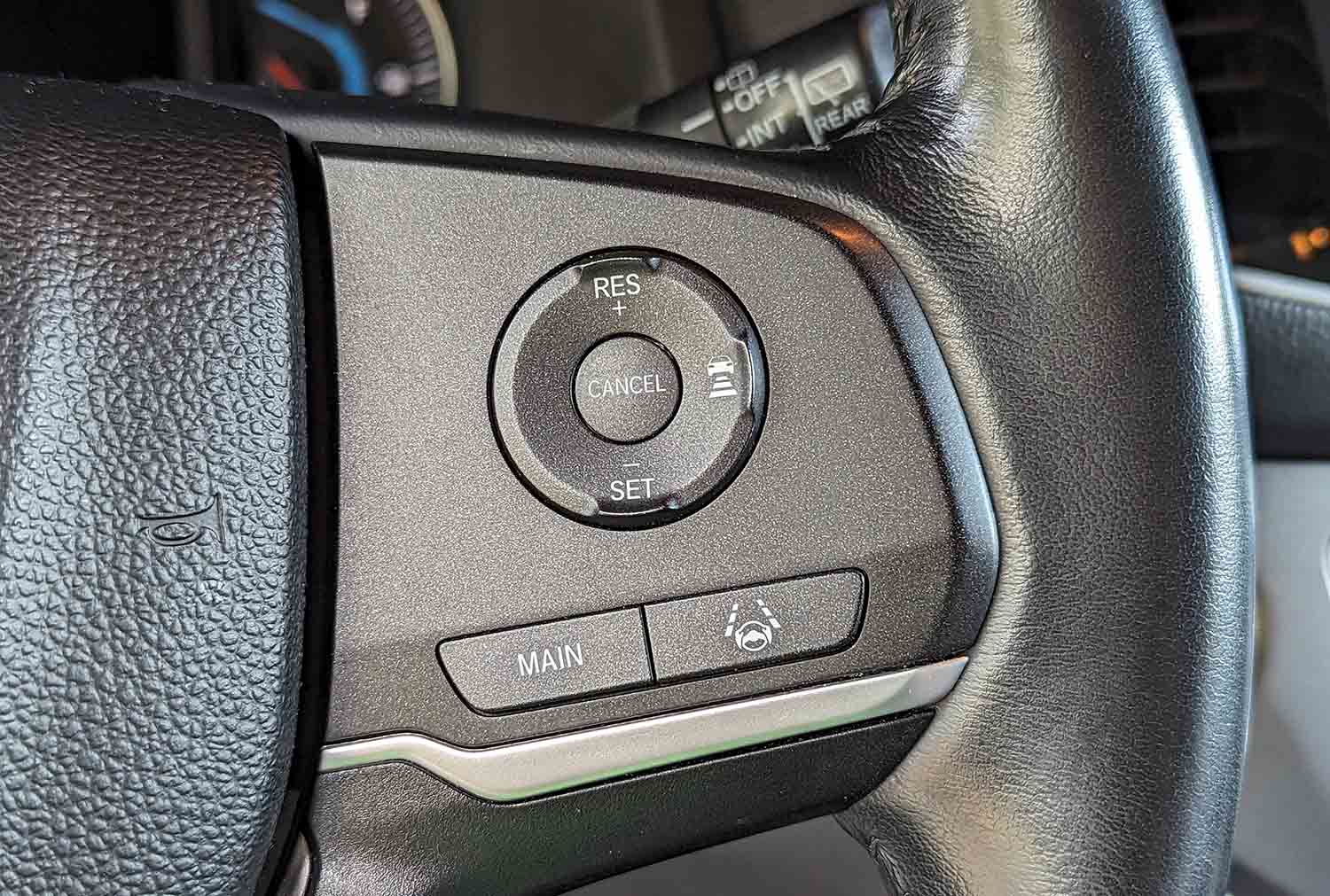  View of advanced driver-assistance system options on steering-wheel controls.