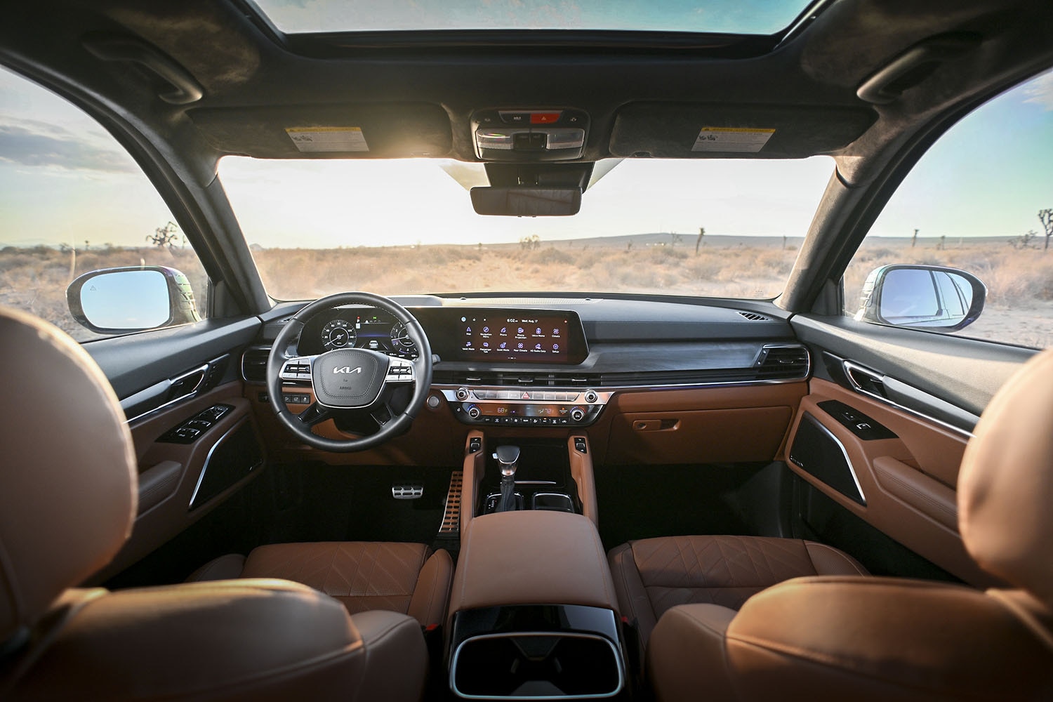  View of the front seats and infotainment screen inside a 2023 Kia Telluride with Quiet Zone