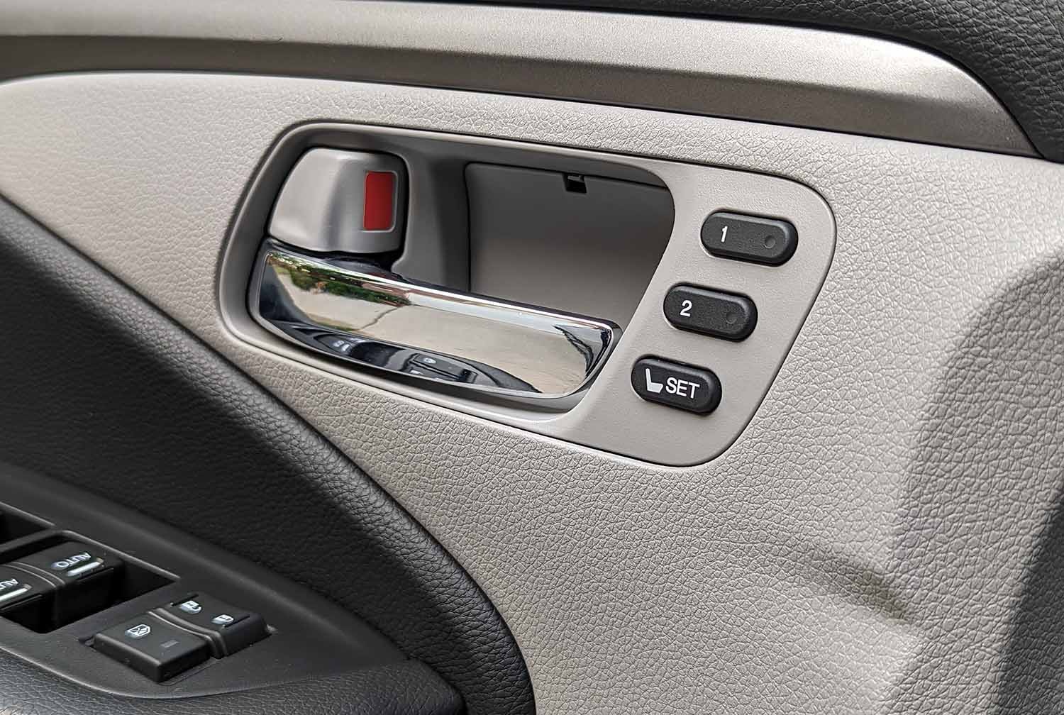  View of memory seat buttons on vehicle interior door.