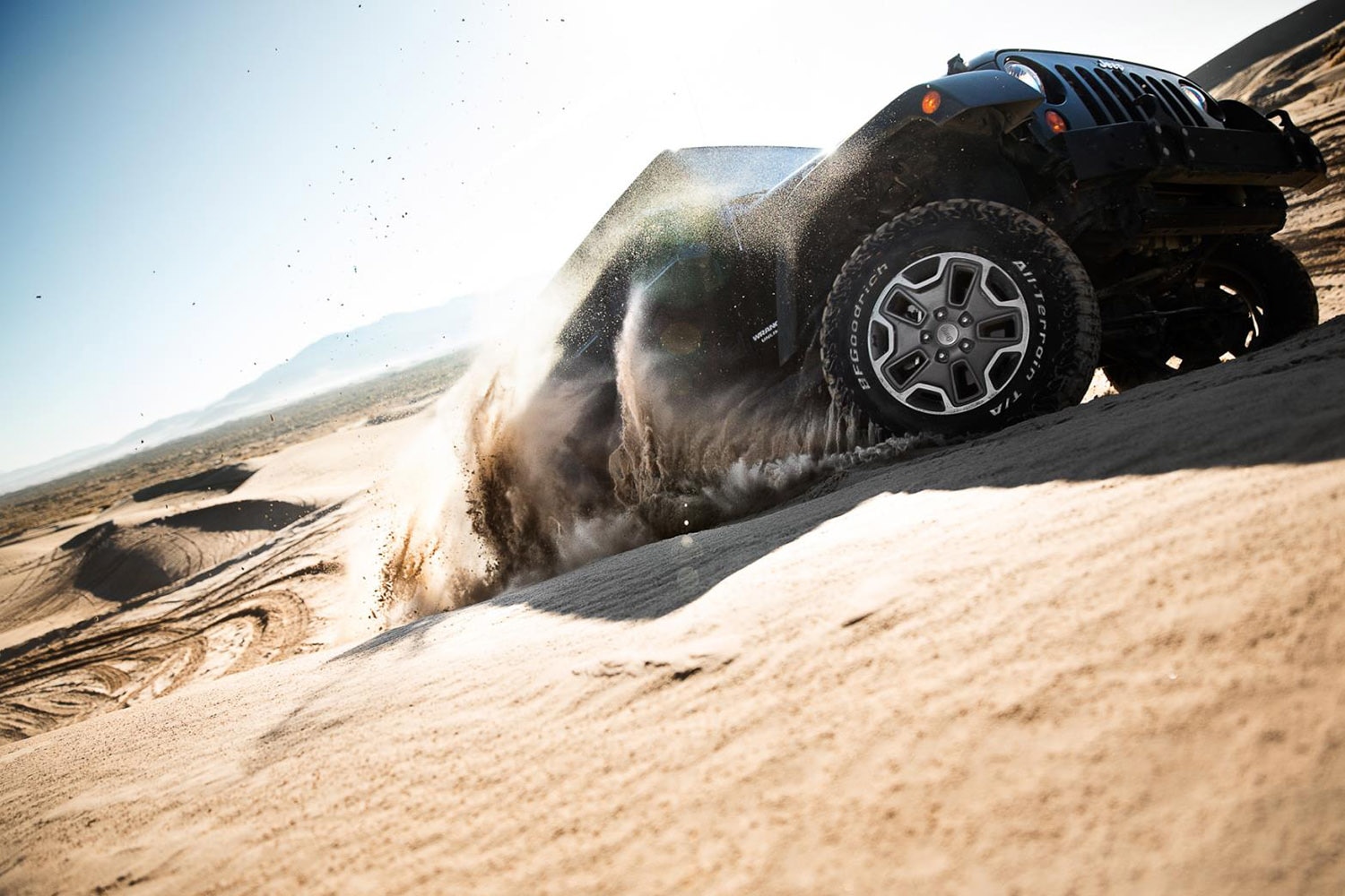 Jeep Wrangler with BFGoodrich all-terrain tires on sand dune.