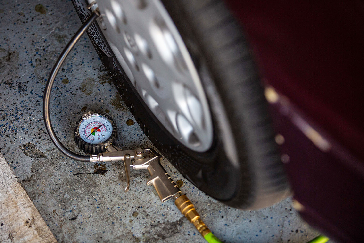 Tire-pressure gauge attached to car tire.