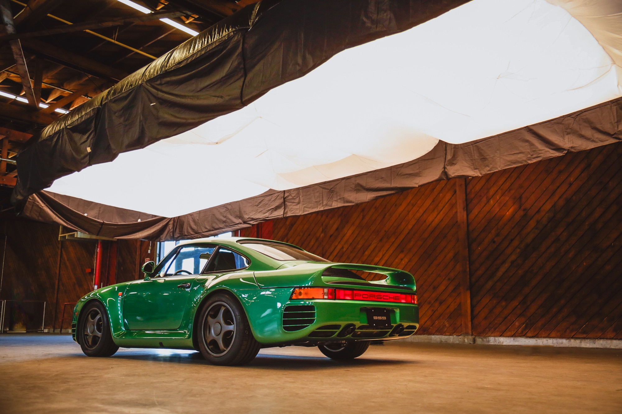 Rear three-quarter shot of a green Canepa-modified Porsche 959 at Luftgekundefinedhlt in Los Angeles in 2017