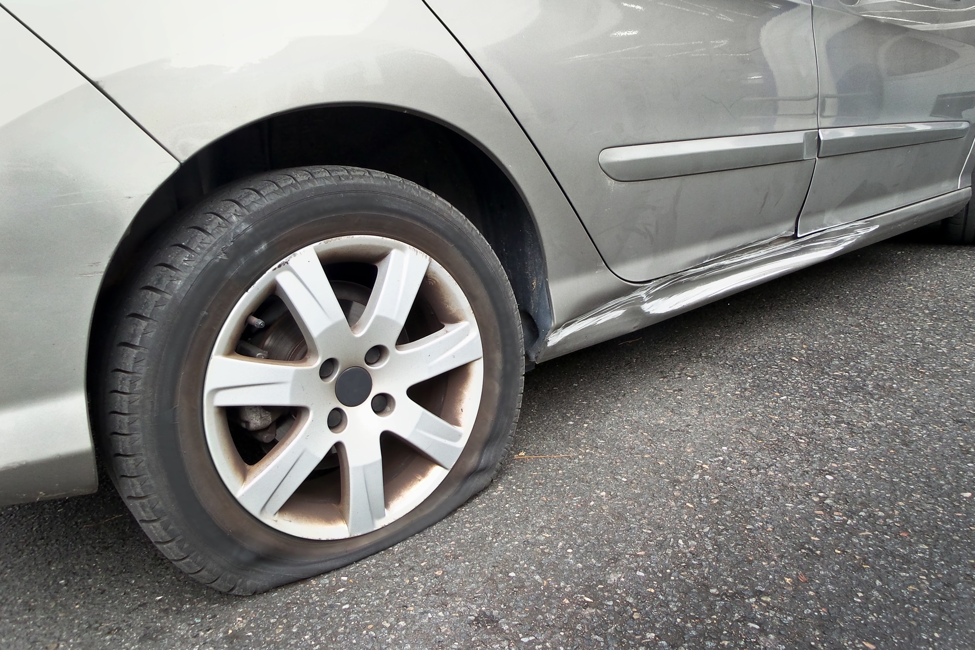 Flat rear tire on a silver car