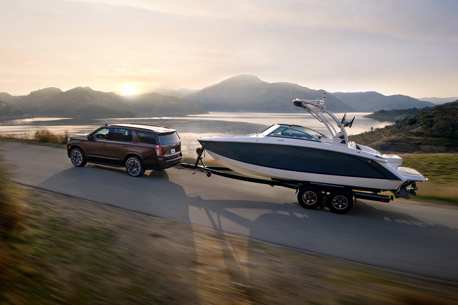 2023 Toyota Sequoia in brown towing a large ski boat