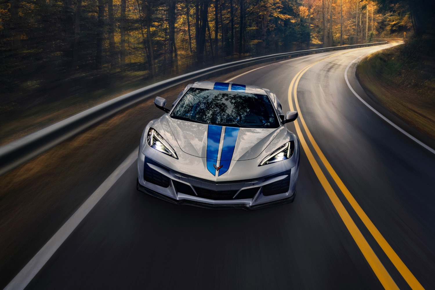 Front overhead action shot of the 2024 Chevrolet Corvette E-Ray in Silver Flare with Electric Blue stripes