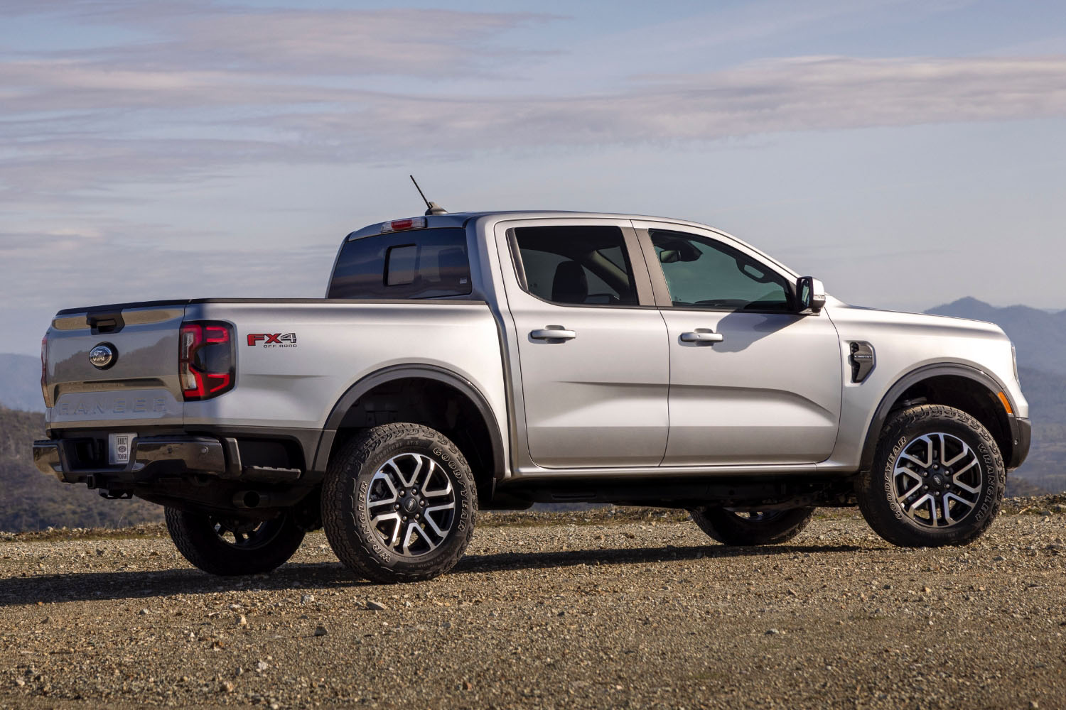 Side view of silver 2024 Ford Ranger with FX4 package parked on dirt 