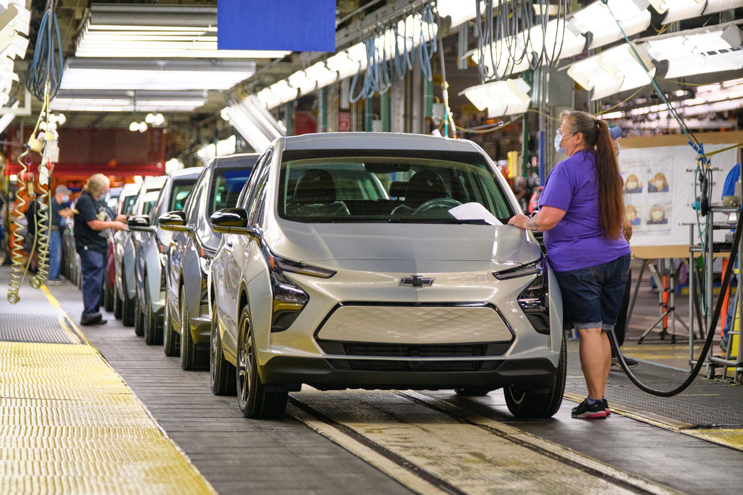 UAW member inspects a Chevrolet Bolt EV on production line in Michigan.