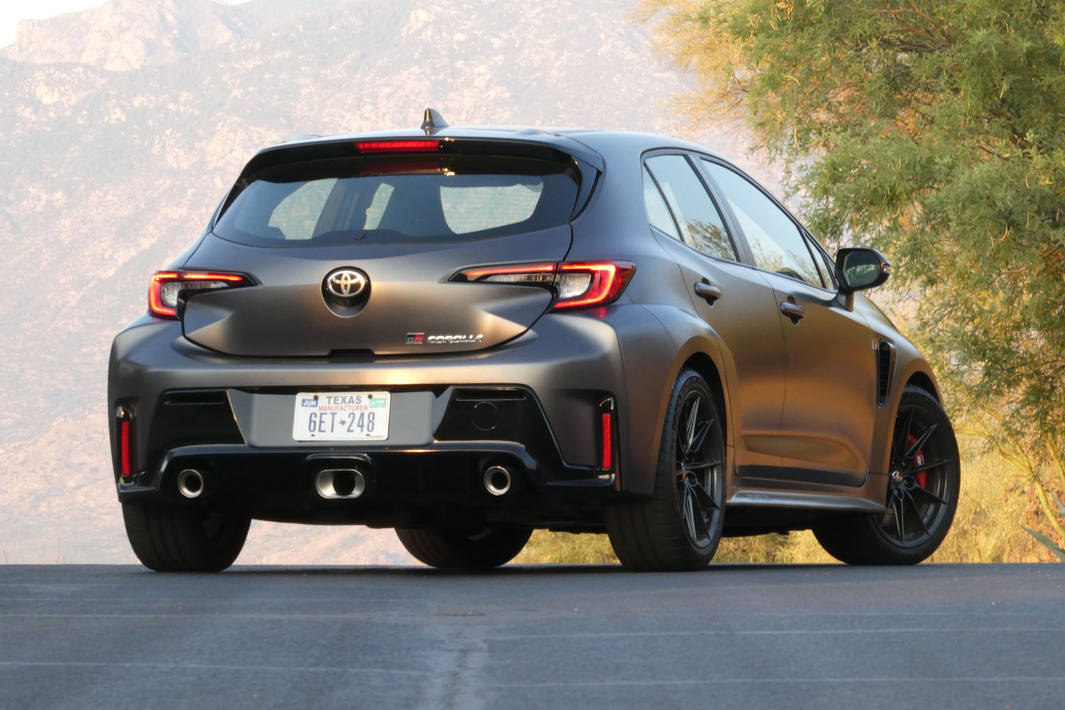 Rear three-quarters view of a 2023 Toyota GR Corolla in Smoke gray.