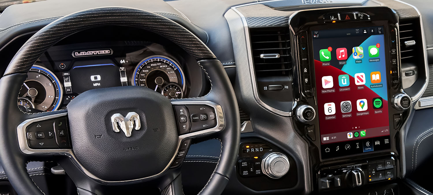 Steering wheel and Apple CarPlay-equipped Uconnect screen of a 2022 Ram 1500