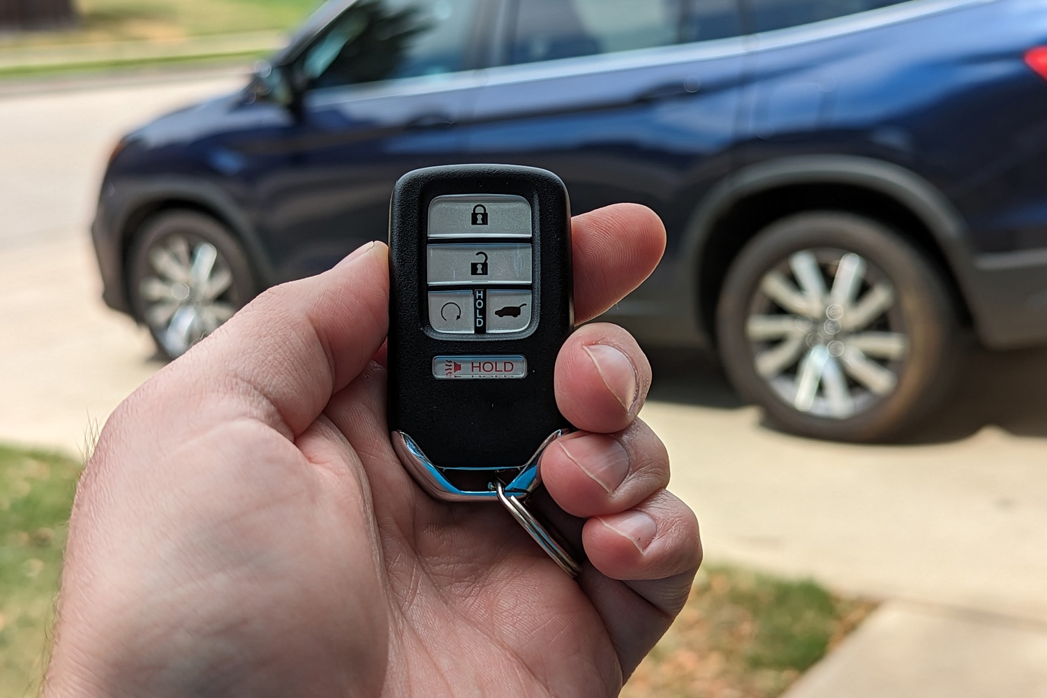 Smart key fob with vehicle in the background