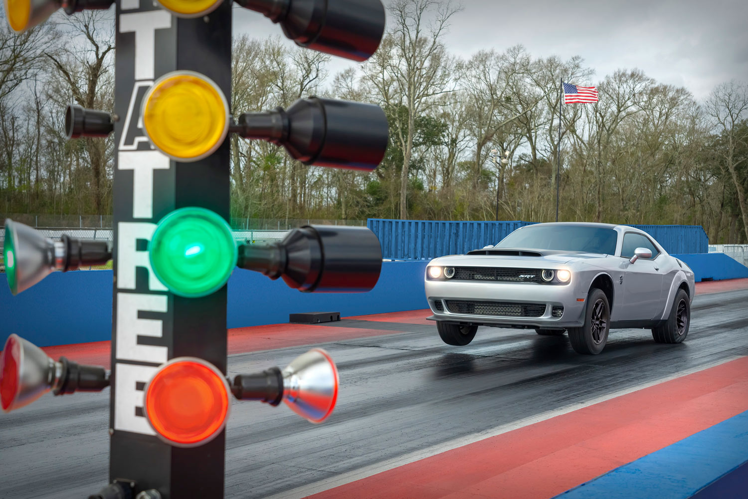 A silver 2023 Dodge Challenger SRT Demon 170 pulling front wheels off the ground at a drag strip