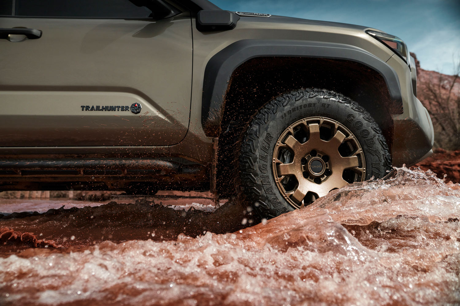 2024 Toyota Tacoma Trailhunter driving through water in desert creek.