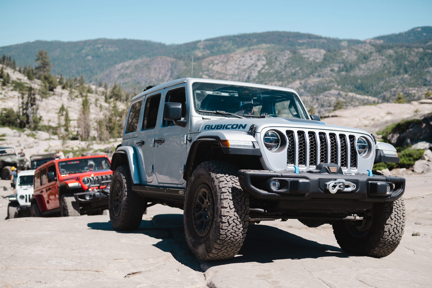 Silver Jeep Wrangler Rubicon leads group of Jeeps off-road