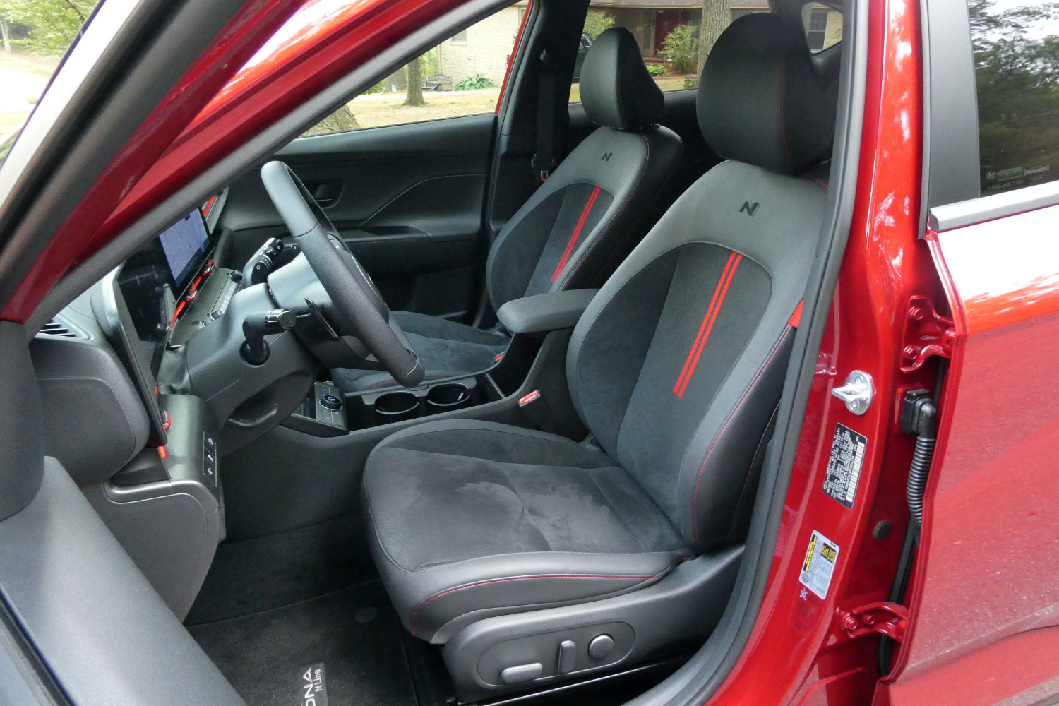 Front seats of a red 2024 Hyundai Kona