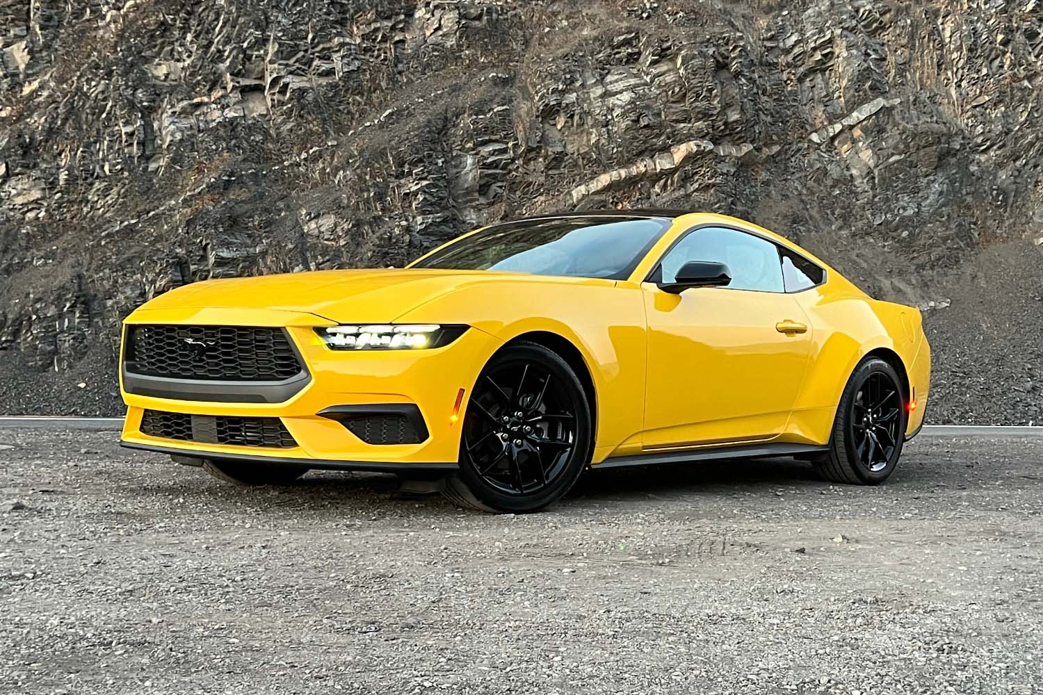 2024 Ford Mustang in Yellow Splash Metallic, front-quarter view.